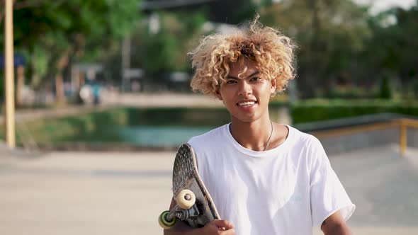 Portrait Of Young Skater With A Skateboard
