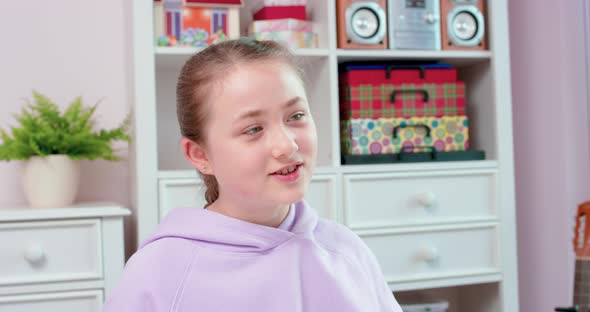 Teen Girl is Playing Guitar and Smiling alt