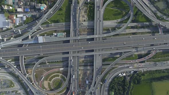 Aerial View of Highway Road Interchange with Busy Urban Traffic Speeding on Road alt