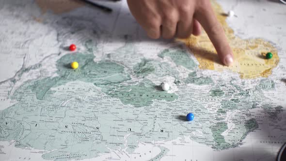 The Process Of Choosing Travel Point On The Map On A Summer Vacation A Young Couple Chooses A Place alt