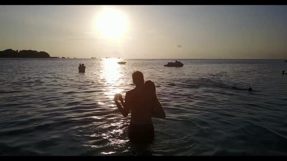 Romantic couple in love on luxury shore beach lifestyle by blue lagoon and white sand background of  alt