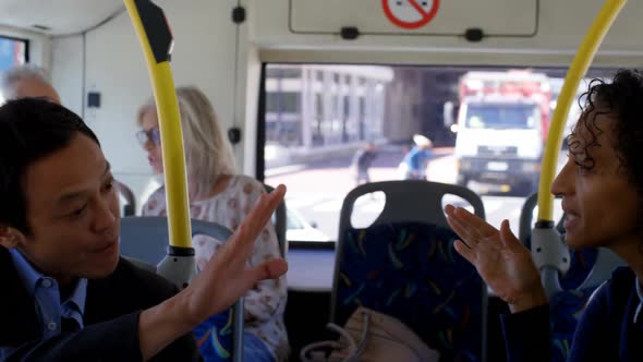 Commuters interacting with each other while travelling in bus 4k alt