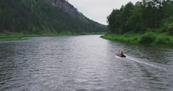 Drone Flies on the Surface of the Water River in the Mountains alt