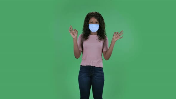 Portrait of Beautiful African American Young Woman in Medical Protective Face Mask Is Looking at alt