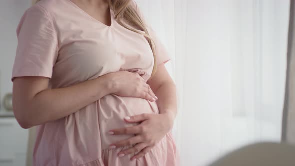 Happy Expectant Woman Stroking Belly alt