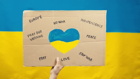 Sign Saying Peace and No War in Ukraine with Blue and Yellow Flag Background alt