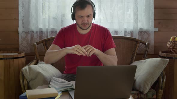 Smart Male Coach Leads Online Lesson, Distance Webinar, Webcam Talk on Laptop alt