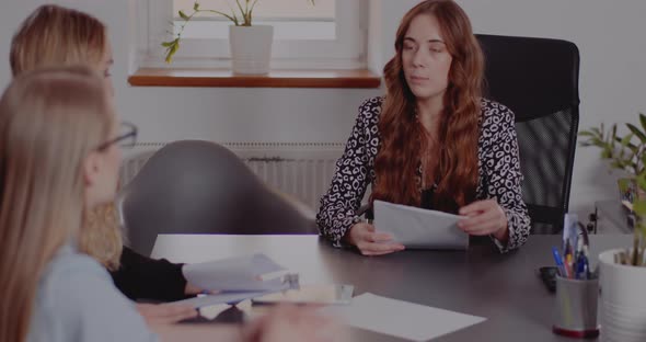 Businesswoman Explaining Colleagues Over Document alt