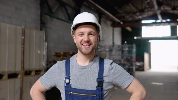 Handsome and Happy Professional Worker in Hat Charmingly Smiling on Camera alt