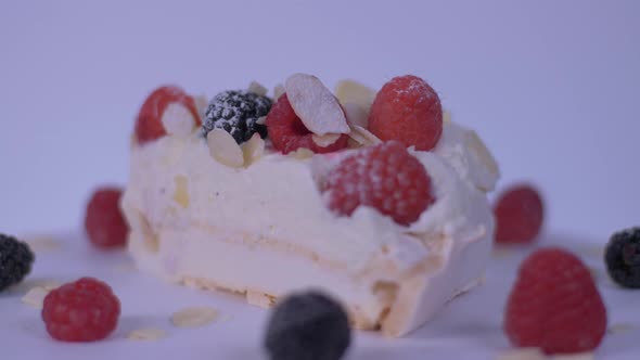 Slice Of Cake Rotating Over White Background. Cake, Berries alt