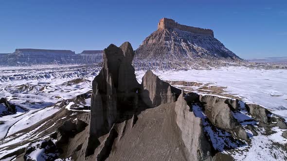 Aerial view of snow over desert landscape in Utah at Factory Butte alt