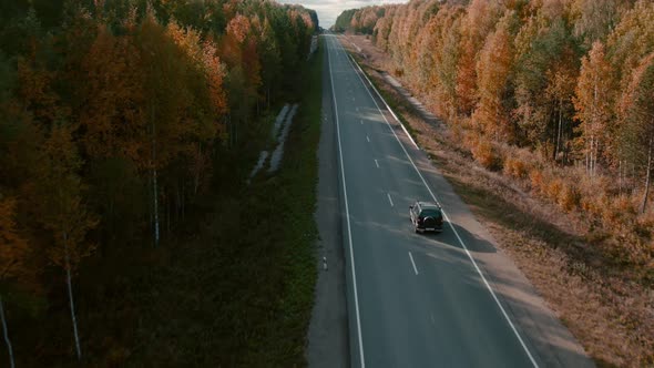 Asphalt road with traffic cars between forest in Ural alt