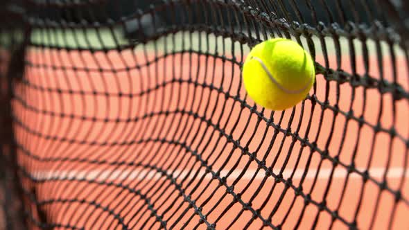 Super Slow Motion Shot of Tennis Ball Hitting the Net on Court at 1000Fps alt