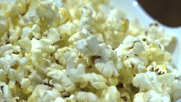 Slowly rotating bowl with freshly baked popcorn