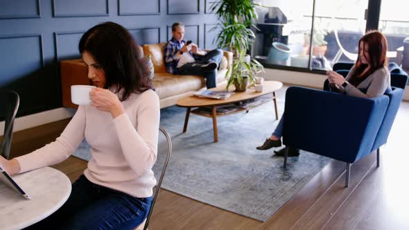 Businesswoman using digital tablet in the lobby at office 4k alt