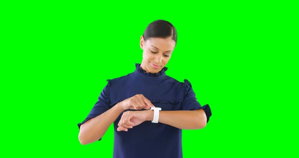 Woman using smartwatch against green screen 4k alt