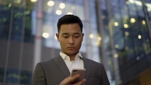 Real Time Portrait Shot of a Young Businessman Conducting Correspondence on the Phone. alt
