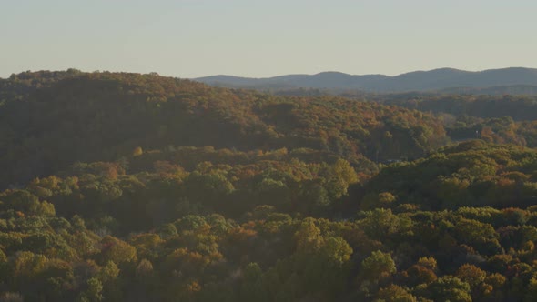 Aerial of autumn over mountain top on a sunny day alt