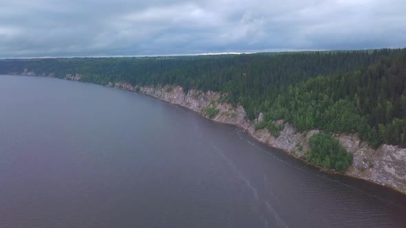 Top View of Rocky Shore of Lake with Forest alt