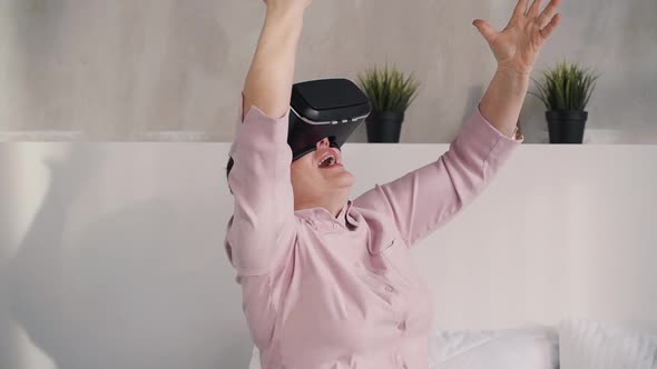 Senior Woman Having Fun with New Futuristic Cyber Game By Vr Glasses.