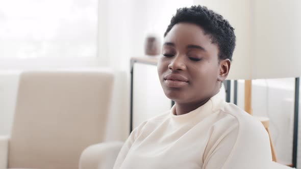 Portrait Afro American Girl Ethnic Model with Short Hair Looking to Side Sitting in Profile at Home alt