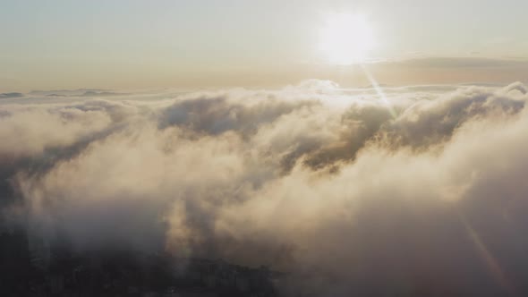 View From a Drone of City Center Above Which Clouds are Rapidly Floating alt