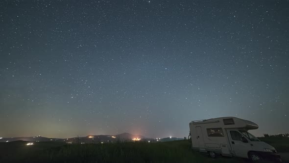 Time lapse: night sky landscape in Orcia Valley, Tuscany, Italy. The Milky Way galaxy and stars over alt