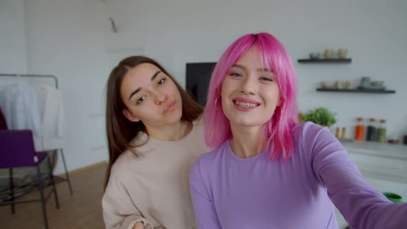 Portrait of Carefree Pretty Women Making Selfie Shot on Cellphone Indoors alt