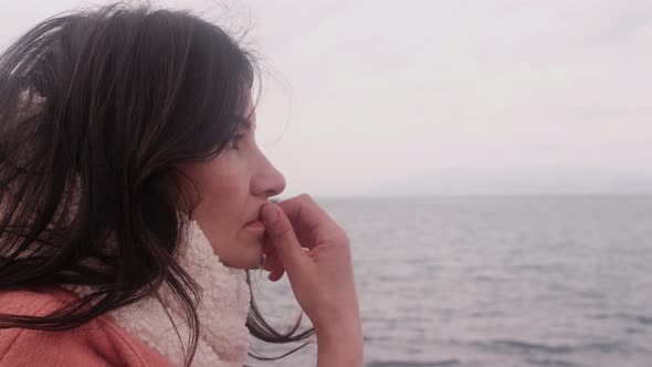 Woman watching the sea thoughtfully