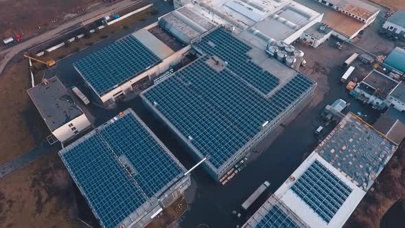 Huge solar farm on rooftop of buildings. Photovoltaic solar panels receive ecological energy from th alt
