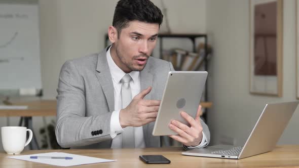 Businessman Reacting to Loss on Tablet alt