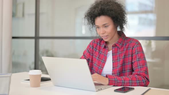 African Woman Talking on Video Call on Laptop alt