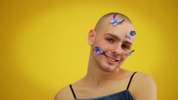 Closeup of Smiling Queer with Butterflies on Face Looking at Camera alt