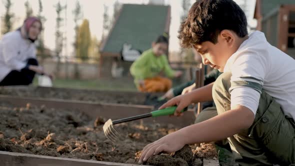 Children Planting In The Garden alt