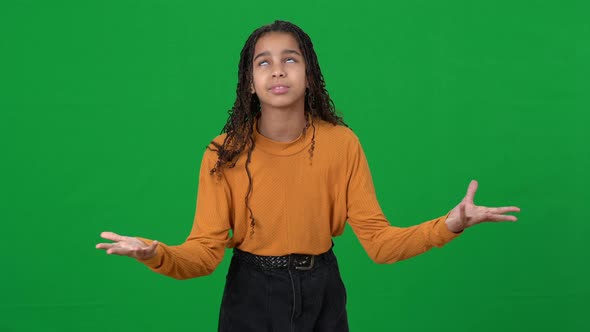 Portrait of Irritated Disappointed Teenager Gesturing at Chromakey Background alt