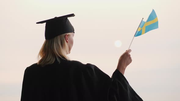 Education in Europe  Graduate in Mantle and Cap with Sweden Flag in Hand alt