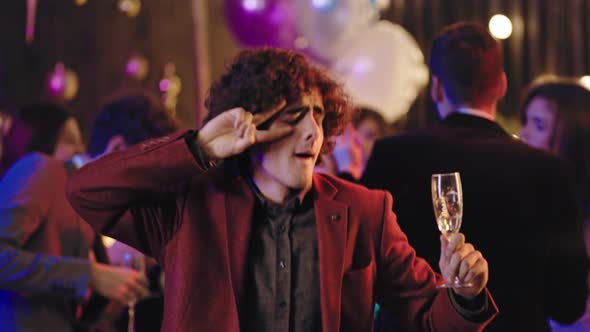 Attractive and Funny Guy with a Curly Hair Holding alt