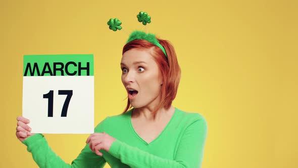 Woman holding calendar with a date for Saint Patrick's Day alt