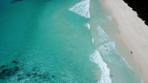 azure beach with big waves from a height