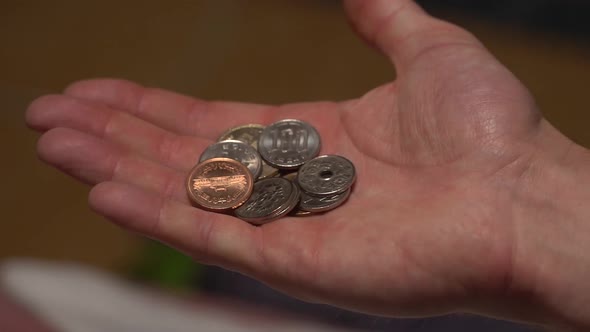 Slow-motion and a close-up shot of Japanese coins and money being thrown and moved between the hands alt