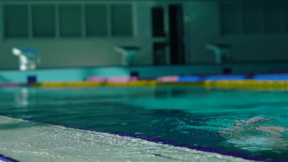Handsome Young Girl Emerges From Under Water in the Swimming Pool. alt