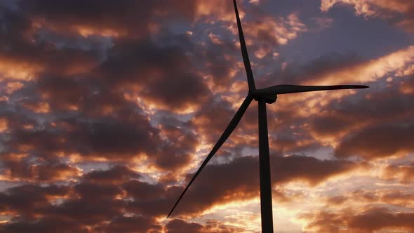 Wind Turbine Produces Clean Energy Against Bright Cloudy Sky