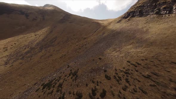 FPV Drone Footage Smooth Stabilized Fly Along Mountain Rocky Hill Around Highland Lake alt