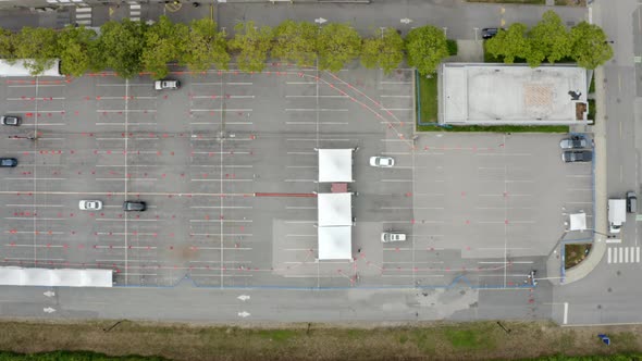 Top View of Cars And Tents At Coronavirus Drive-Thru Testing And Vaccination Site. aerial alt