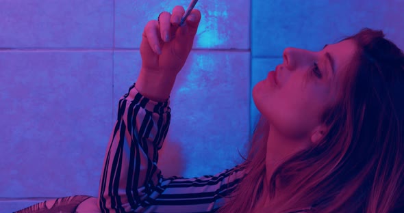 high on drugs - stoned woman smokes a joint to escape from reality alt