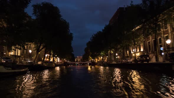 Timelapse of traveling on Amsterdam canals at night alt