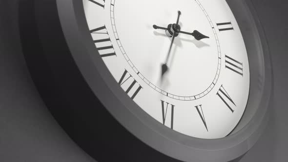 Latin Clock Face In Time Lapse On Dark Grey Wall  alt