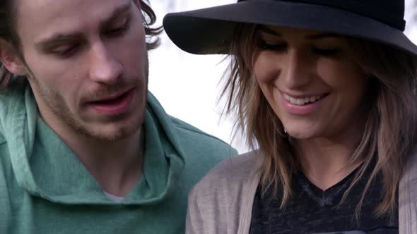 Man and woman looking at tablet and talking about what they see alt