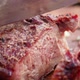 Meat being cut into pieces with a knife on a wooden board - VideoHive Item for Sale