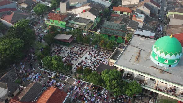 Aerial View of People offering prayers on the Eid morning at famous mosque Jama Masjid in Bekasi. alt